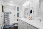 Jack-and-Jill guest bathroom with walk-shower and double vanity